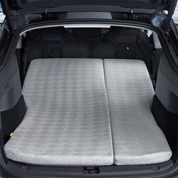 Rear view of a Tesla Model Y Juniper trunk area with the 3W custom split memory foam sleeping mattress fully extended for dual person car camping.